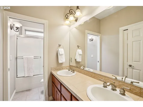 a bathroom with a sink vanity granite and a mirror