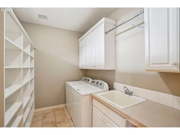 a utility room with sink dryer and washer