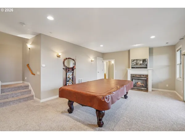 a living room with furniture a table and kitchen view