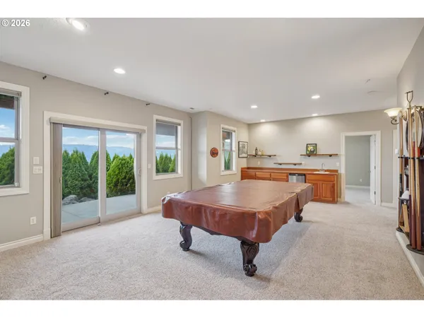 a room with pool table and windows
