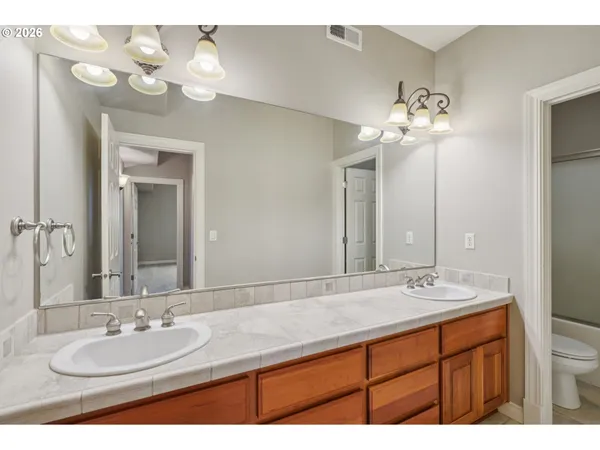 a bathroom with a double vanity sink and a mirror