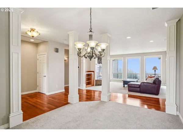 a living room with kitchen island furniture and a chandelier