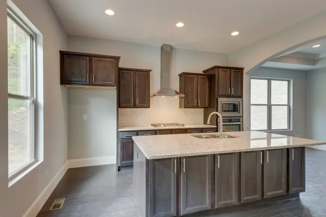 a bathroom with a granite countertop sink a large mirror and vanity