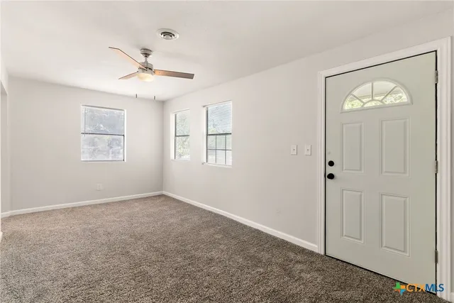 a view of an empty room with a window