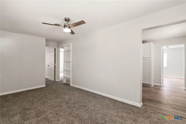 a view of an empty room and wooden floor