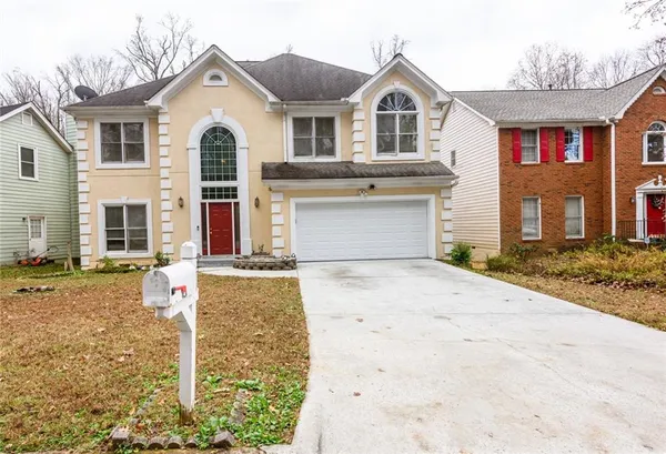 a front view of a house with a yard and garage