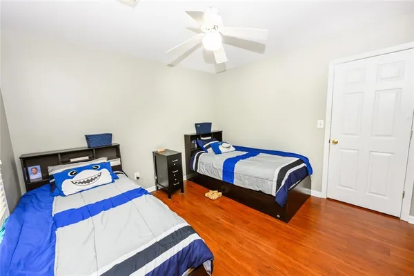 a bedroom with two beds and a window