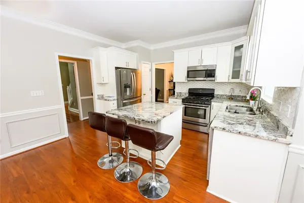 a kitchen with a stove a sink and a refrigerator