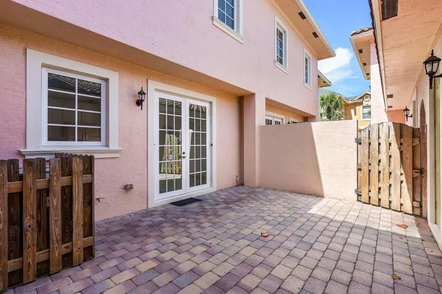 a view of a house with wooden fence