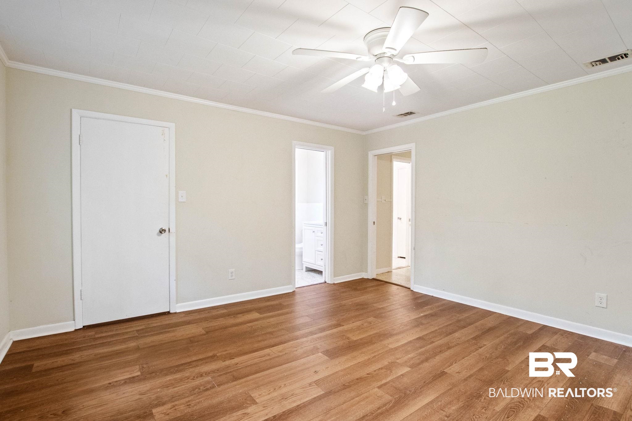 384 Old Bratt Road Atmore, AL 36502 - Photo 36 of 64 Spacious room featuring wood-finish flooring, light neutral wall paint, and white trim