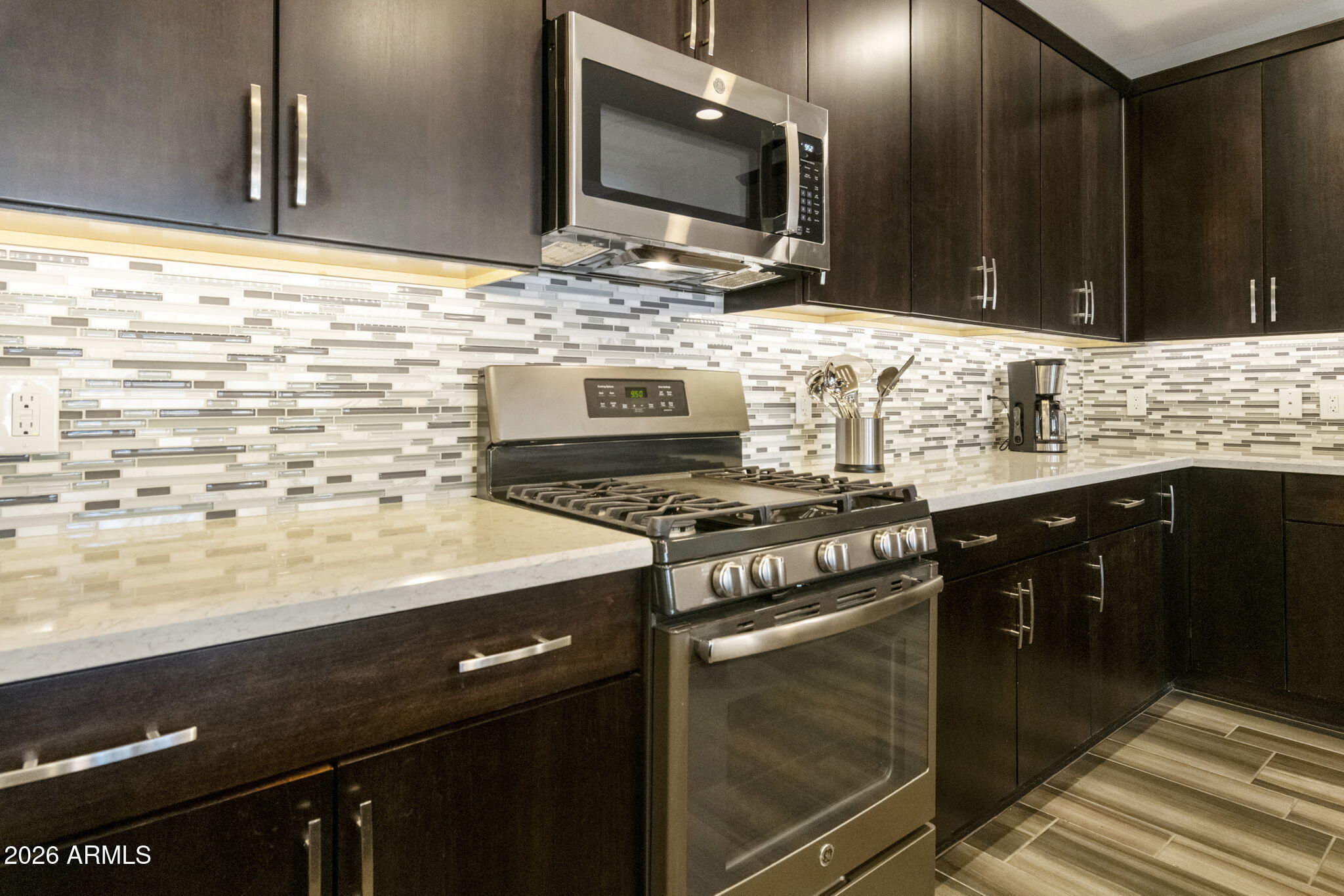 4777 South Fulton Ranch Boulevard, Unit 1086 Chandler, AZ 85248 - Photo 13 of 67 a kitchen with stainless steel appliances a stove and a microwave