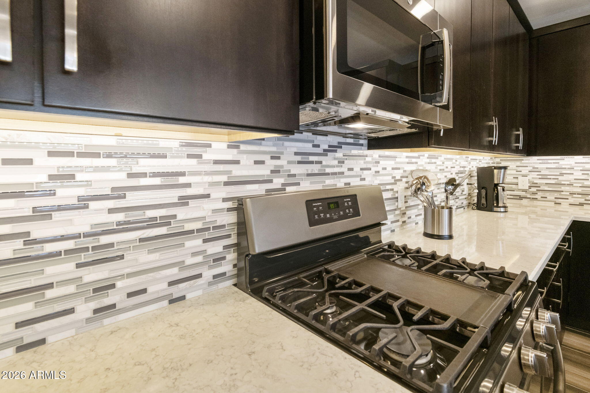4777 South Fulton Ranch Boulevard, Unit 1086 Chandler, AZ 85248 - Photo 14 of 67 a stove top oven sitting inside of a kitchen
