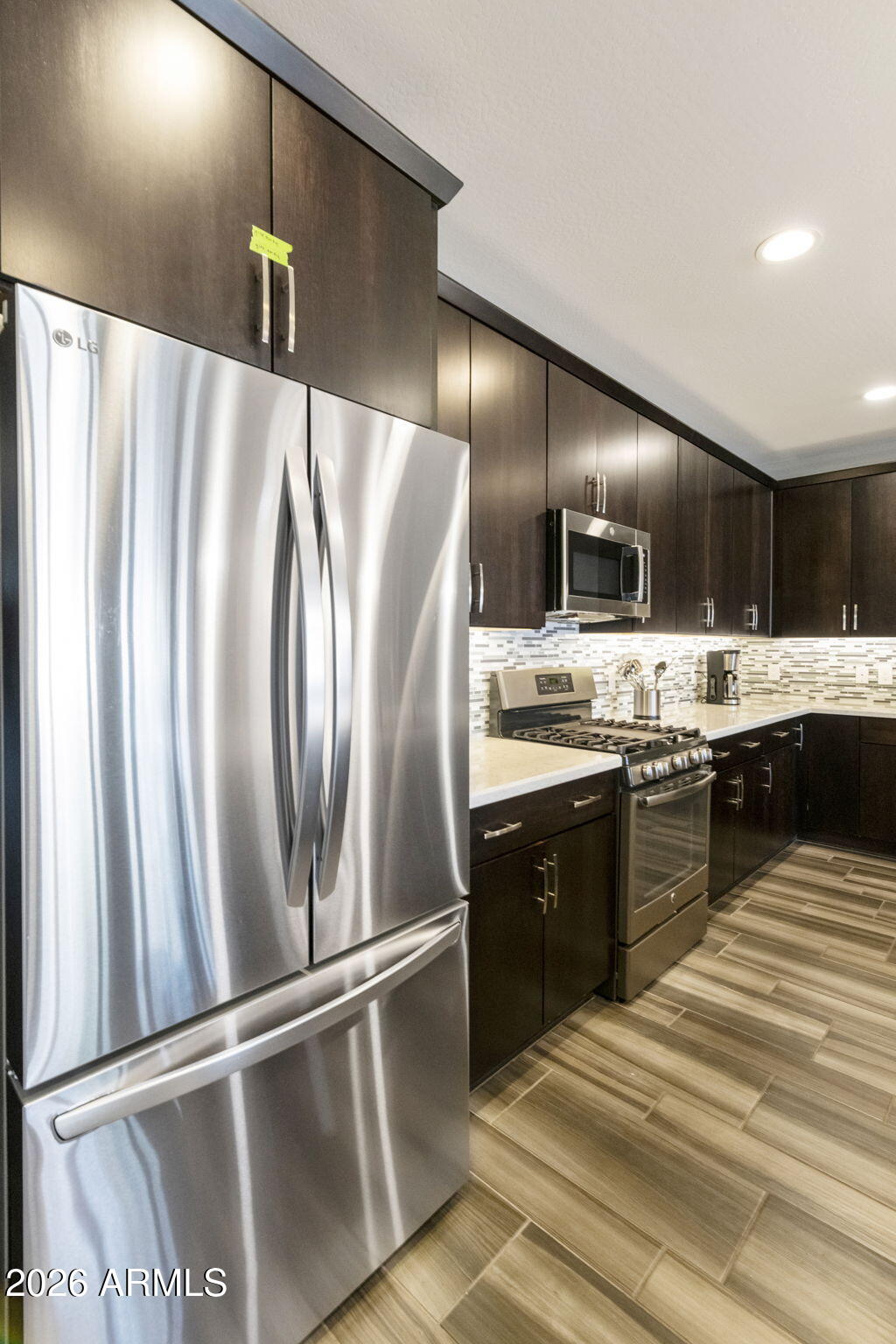 4777 South Fulton Ranch Boulevard, Unit 1086 Chandler, AZ 85248 - Photo 17 of 67 a kitchen with granite countertop stainless steel appliances and wooden cabinets