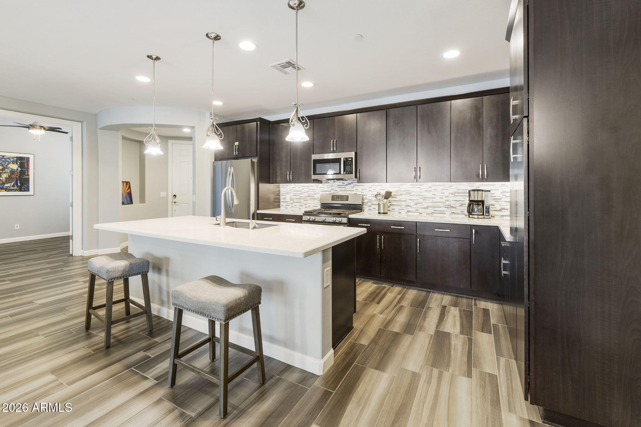 4777 South Fulton Ranch Boulevard, Unit 1086 Chandler, AZ 85248 - Photo 2 of 67 a kitchen with kitchen island granite countertop a sink and cabinets