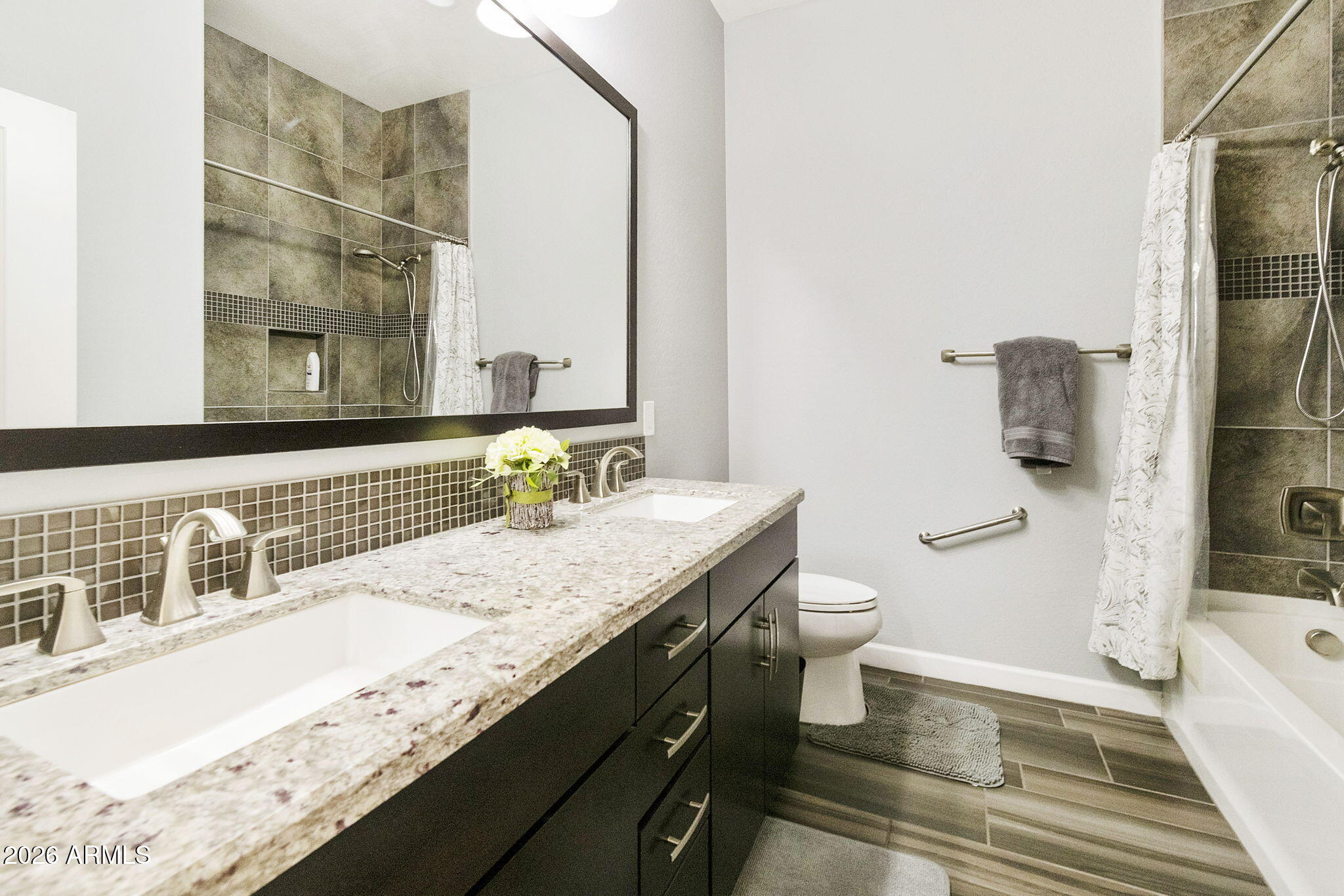 4777 South Fulton Ranch Boulevard, Unit 1086 Chandler, AZ 85248 - Photo 22 of 67 a bathroom with a granite countertop sink a toilet a mirror and shower