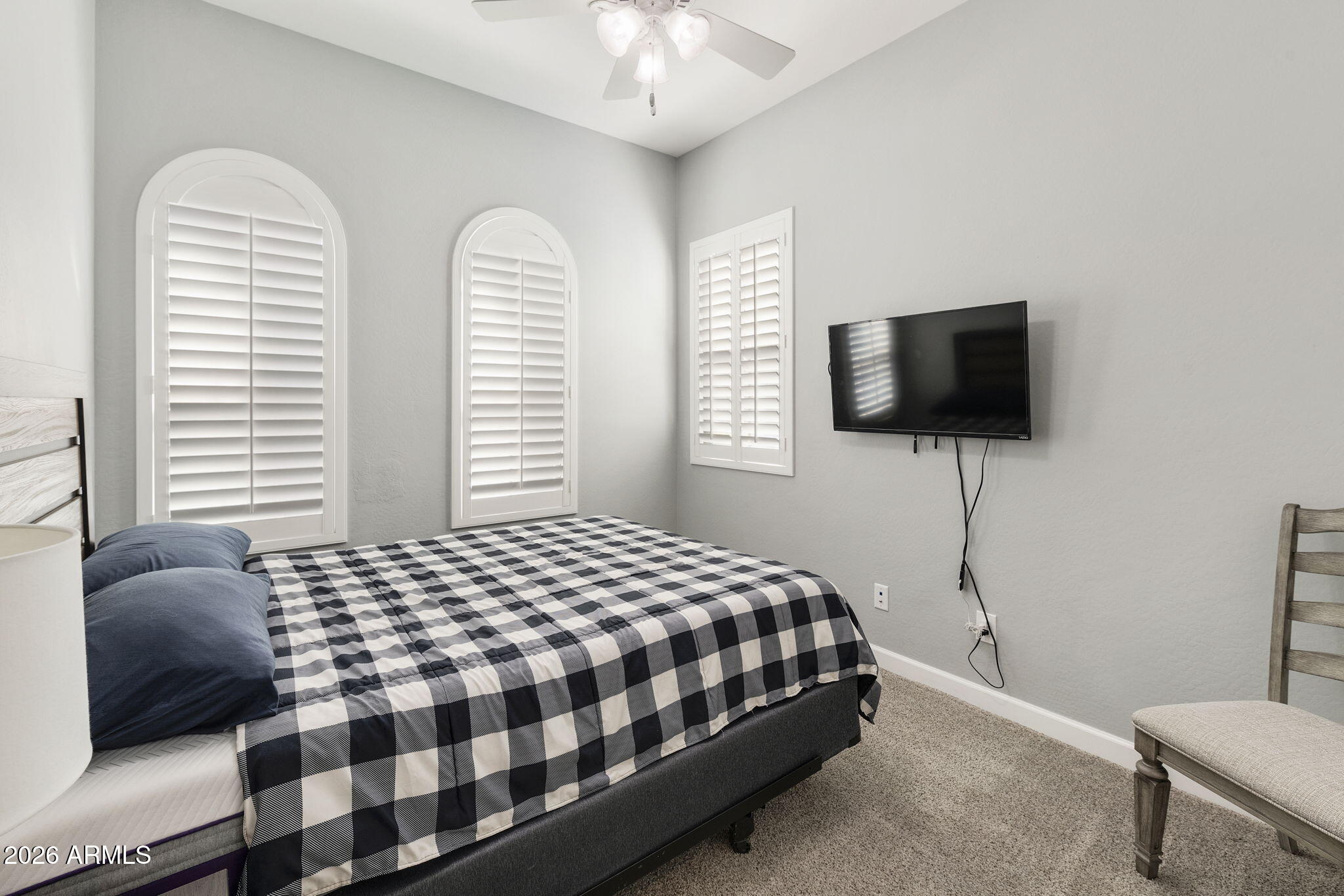 4777 South Fulton Ranch Boulevard, Unit 1086 Chandler, AZ 85248 - Photo 26 of 67 a bedroom with a bed a flat screen tv and a large window