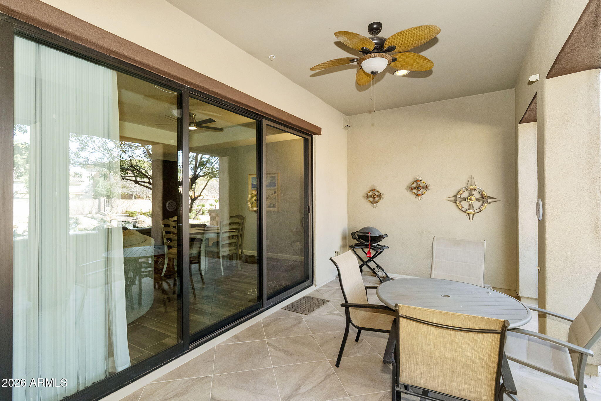 4777 South Fulton Ranch Boulevard, Unit 1086 Chandler, AZ 85248 - Photo 38 of 67 a room with chandelier fan and glass door