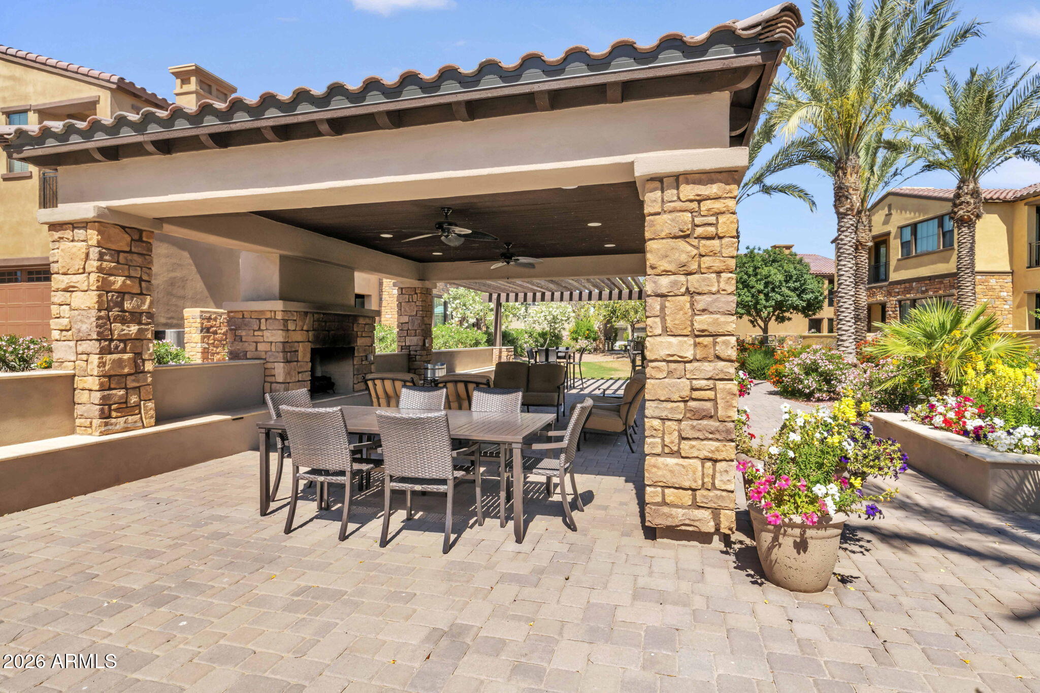 4777 South Fulton Ranch Boulevard, Unit 1086 Chandler, AZ 85248 - Photo 49 of 67 a view of a patio with dining table and chairs potted plants
