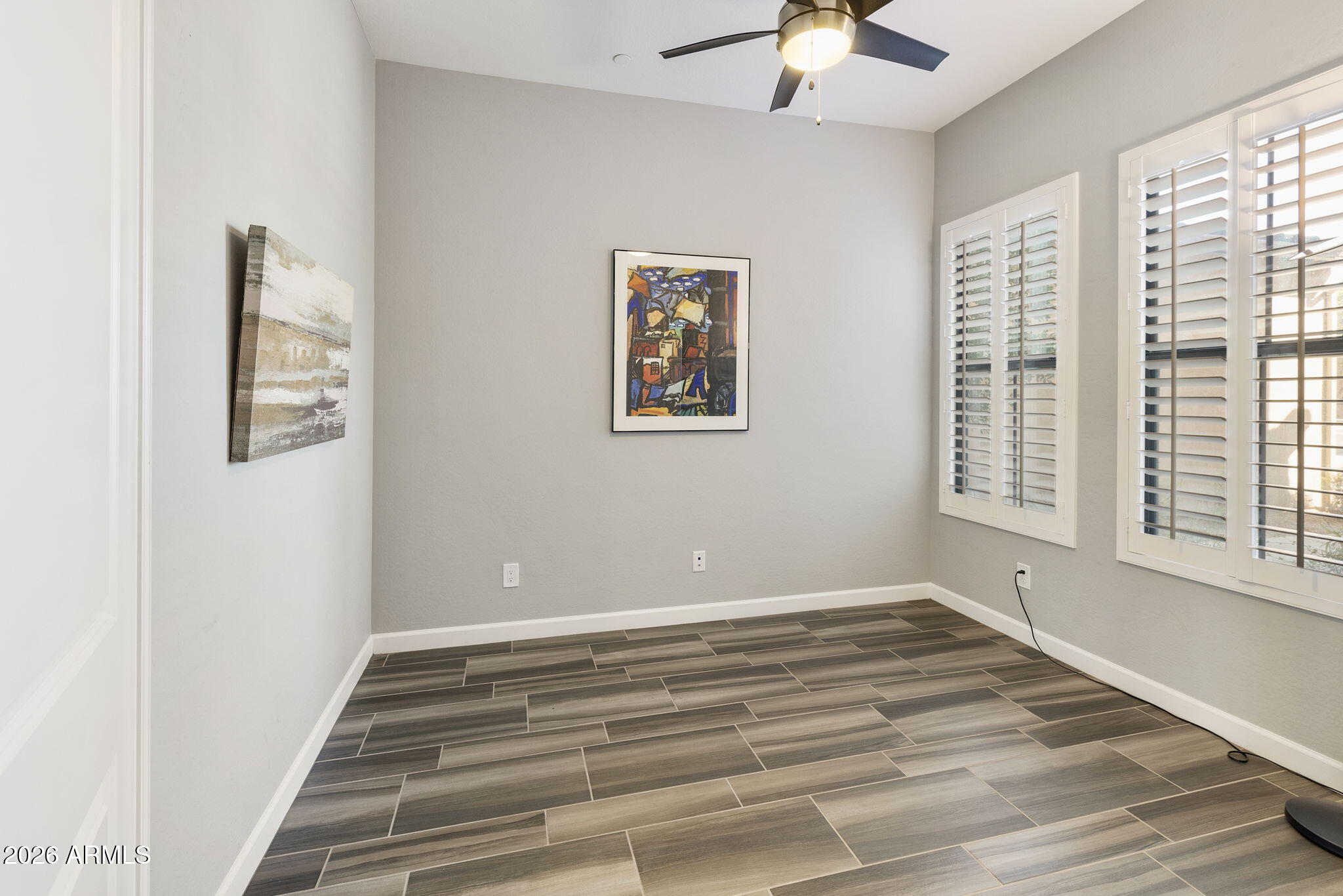 4777 South Fulton Ranch Boulevard, Unit 1086 Chandler, AZ 85248 - Photo 9 of 67 a view of an empty room with a window and a ceiling fan