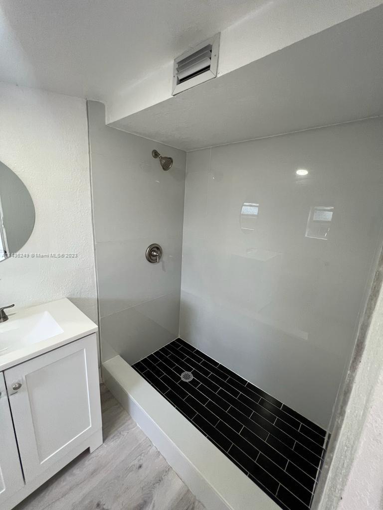 5836 Hope Street Hollywood, FL 33021 - Photo 15 of 24 a bathroom with a sink a toilet a vanity and mirror