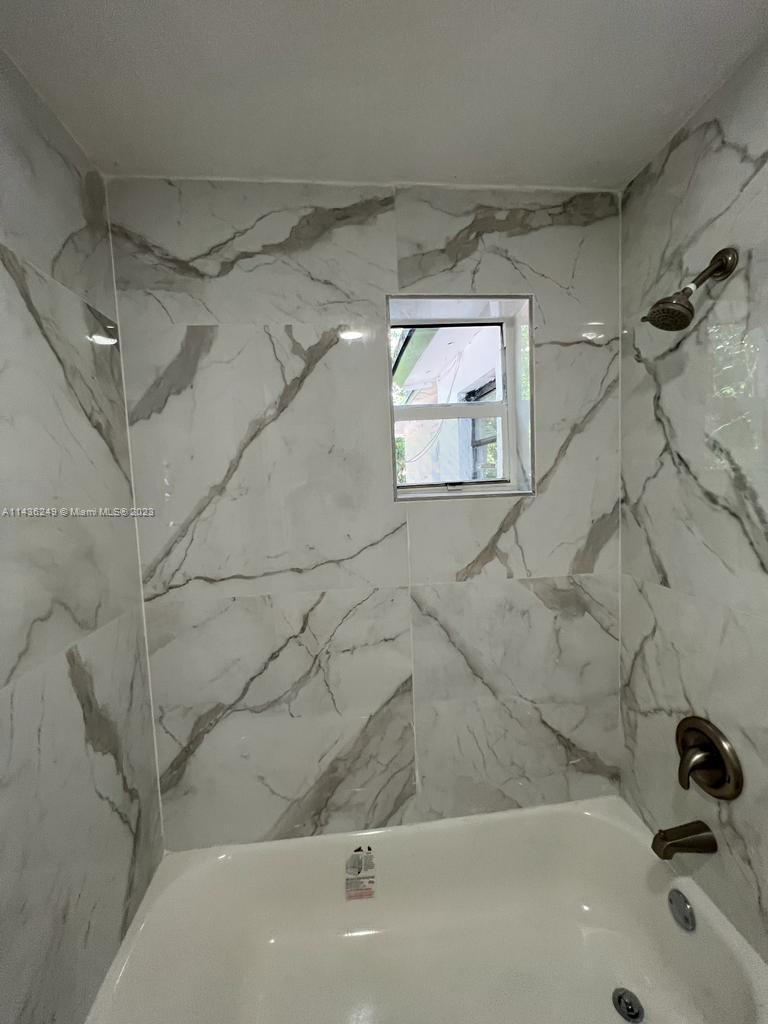 5836 Hope Street Hollywood, FL 33021 - Photo 20 of 24 a bathroom with a bathtub
