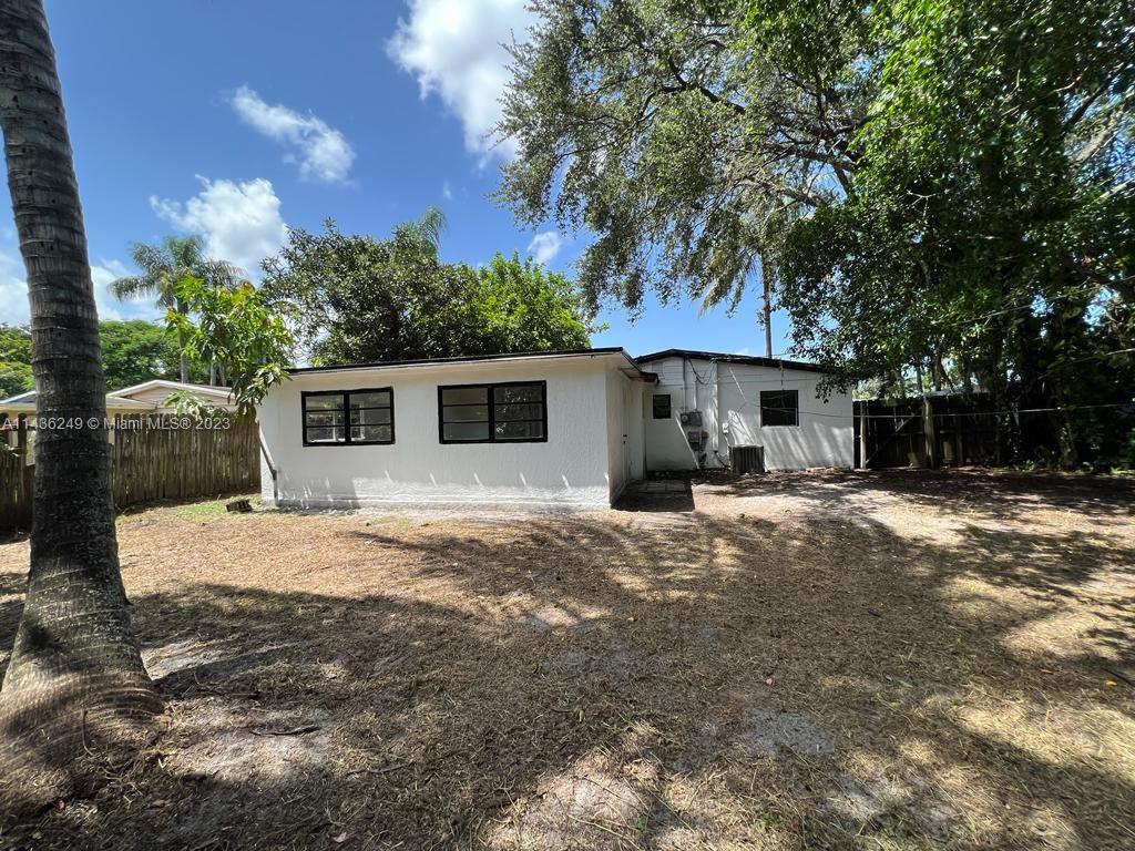 5836 Hope Street Hollywood, FL 33021 - Photo 23 of 24 a front view of a house with a yard and garage
