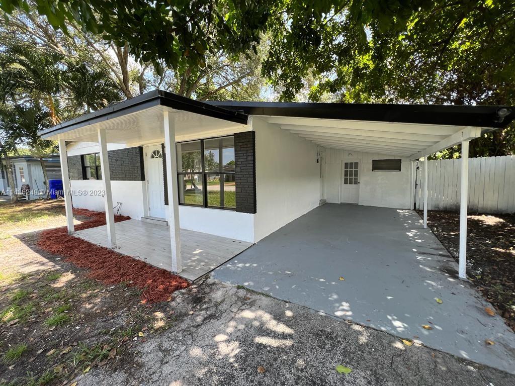 5836 Hope Street Hollywood, FL 33021 - Photo 3 of 24 a front view of a house with a yard
