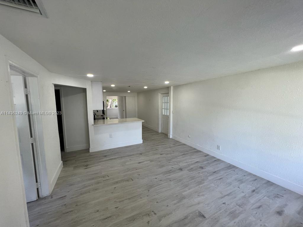 5836 Hope Street Hollywood, FL 33021 - Photo 4 of 24 a view of kitchen with refrigerator stove and wooden floor