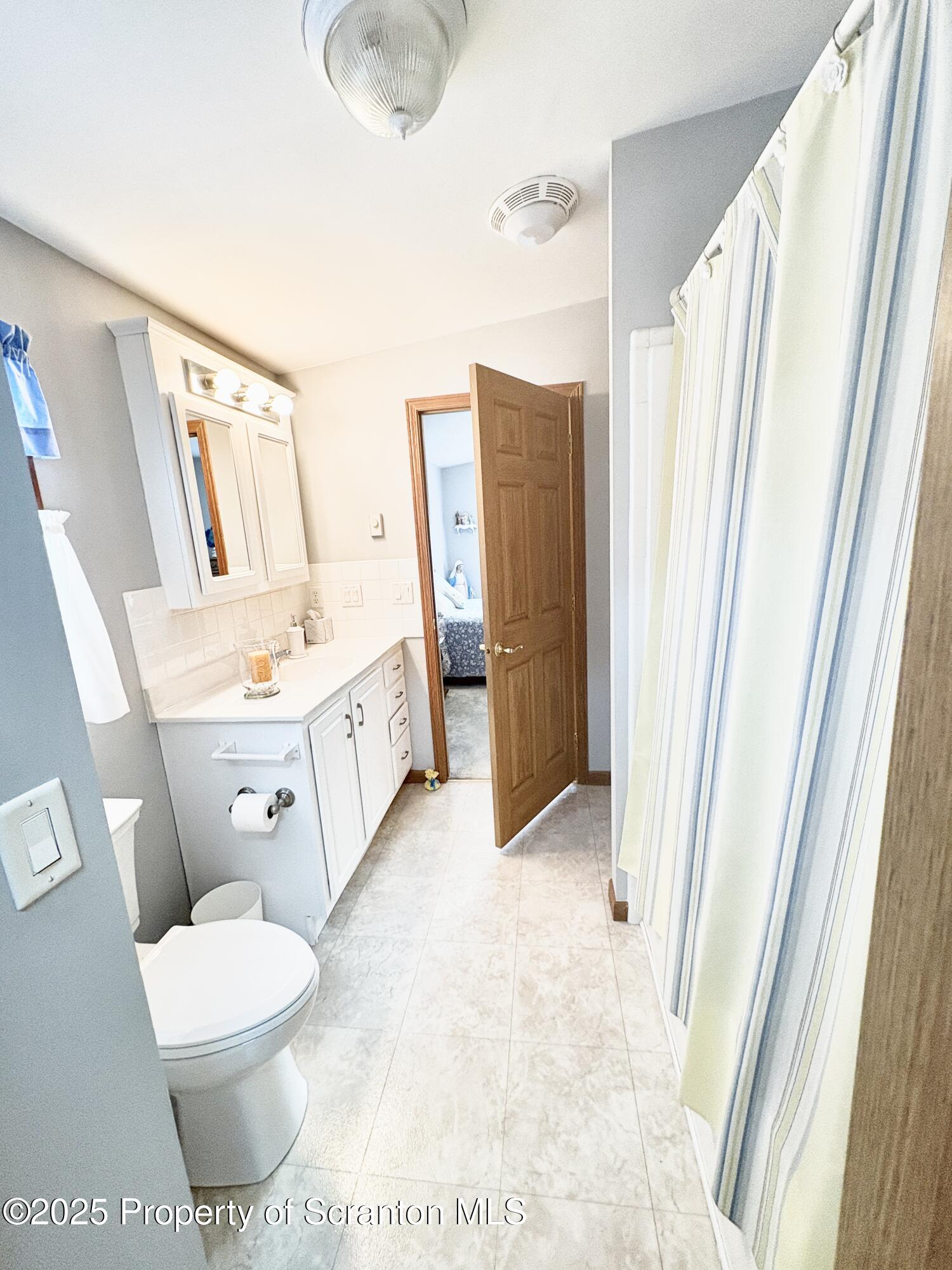 813 Poplar Street Clarks Summit, PA 18411 - Photo 8 of 33 a bathroom with a toilet sink and a mirror