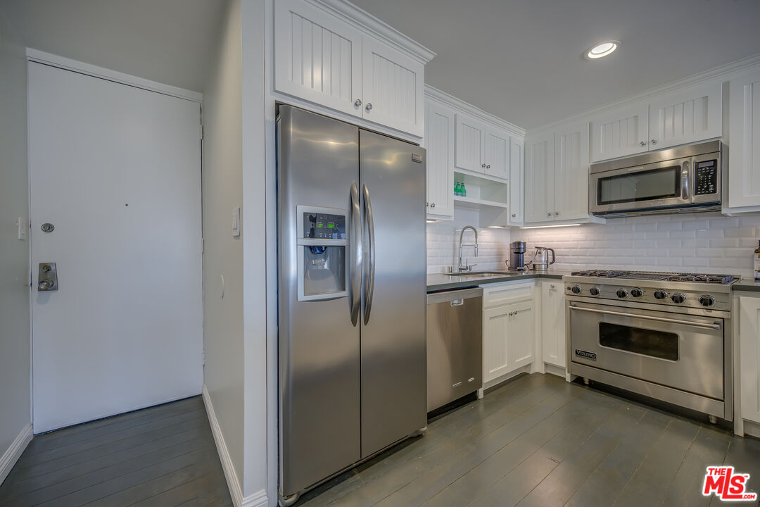 2 Ketch Street, Unit 107 Marina del Rey, CA 90292 - Photo 13 of 23 a kitchen with stainless steel appliances granite countertop a refrigerator and a stove top oven