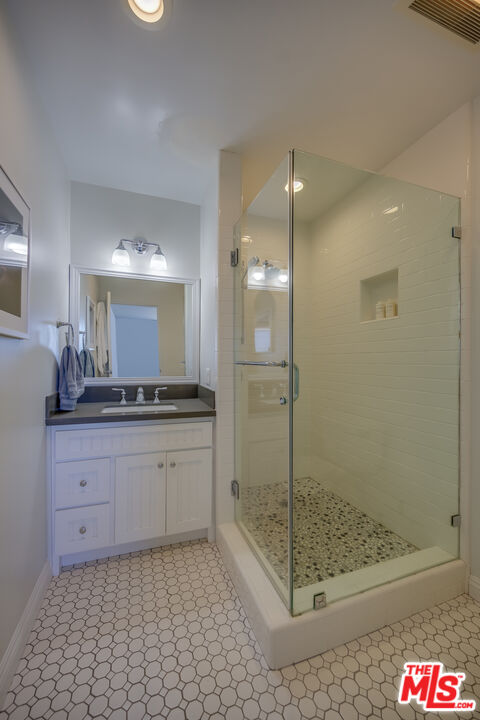 2 Ketch Street, Unit 107 Marina del Rey, CA 90292 - Photo 18 of 23 a bathroom with a mirror and a shower
