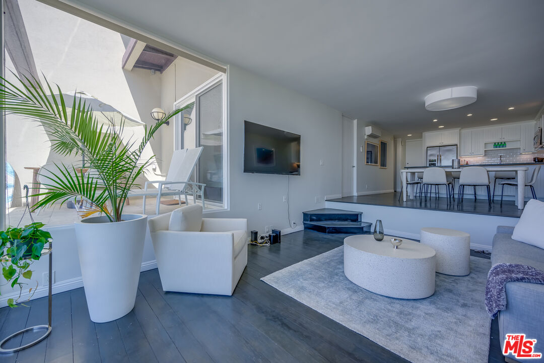 2 Ketch Street, Unit 107 Marina del Rey, CA 90292 - Photo 7 of 23 a living room with furniture and a potted plant