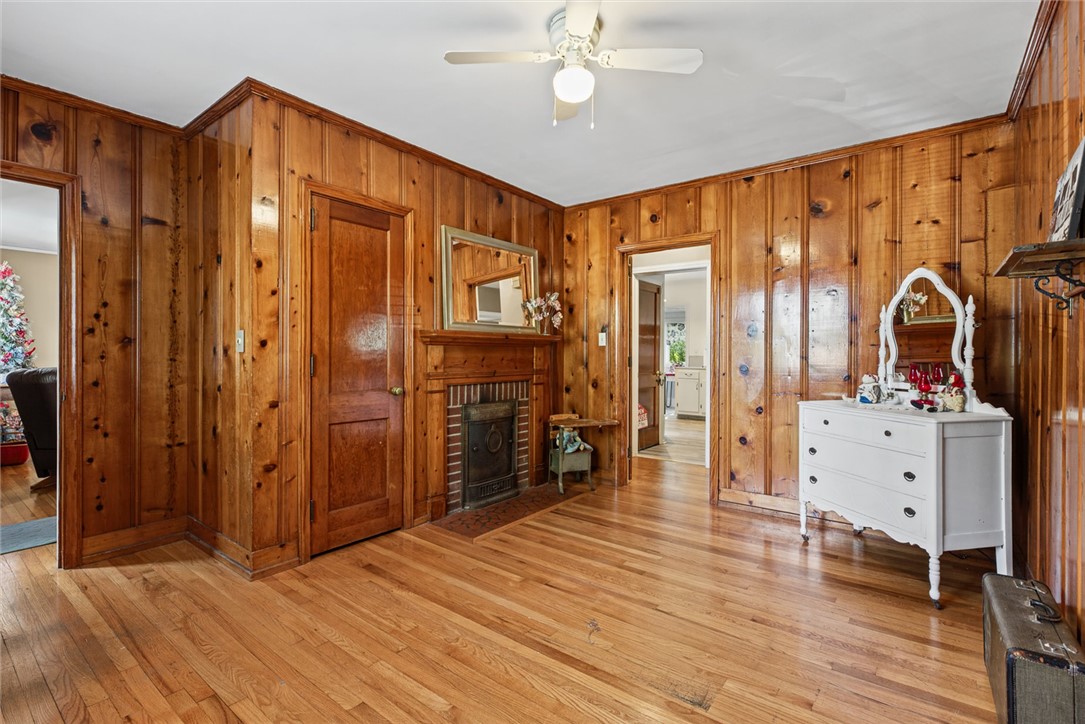 2028 Moultrie Square Anderson, SC 29621 - Photo 15 of 30 Warm wood paneling and matching hardwood floors frame a cozy brick fireplace.