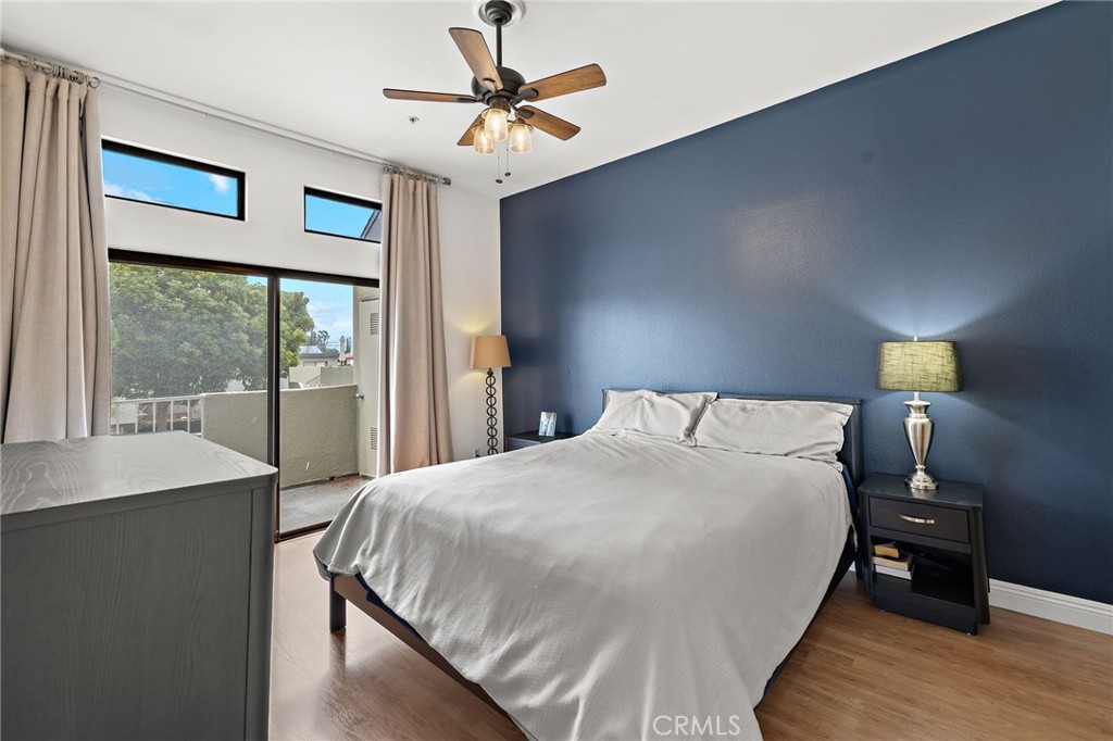 17641 Sergio Circle, Unit 203 Huntington Beach, CA 92647 - Photo 12 of 25 a bedroom with a bed and a table