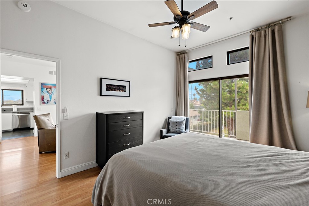 17641 Sergio Circle, Unit 203 Huntington Beach, CA 92647 - Photo 17 of 25 a bedroom with a large bed and a chandelier