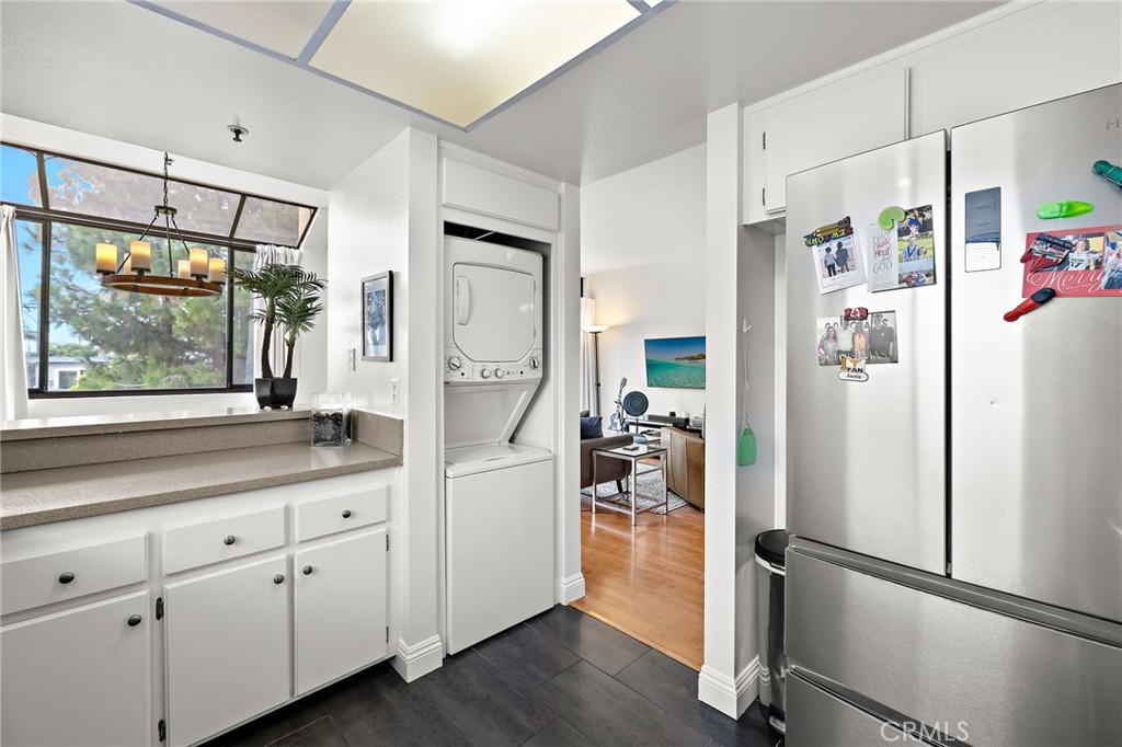 17641 Sergio Circle, Unit 203 Huntington Beach, CA 92647 - Photo 10 of 25 a kitchen with a refrigerator and a sink