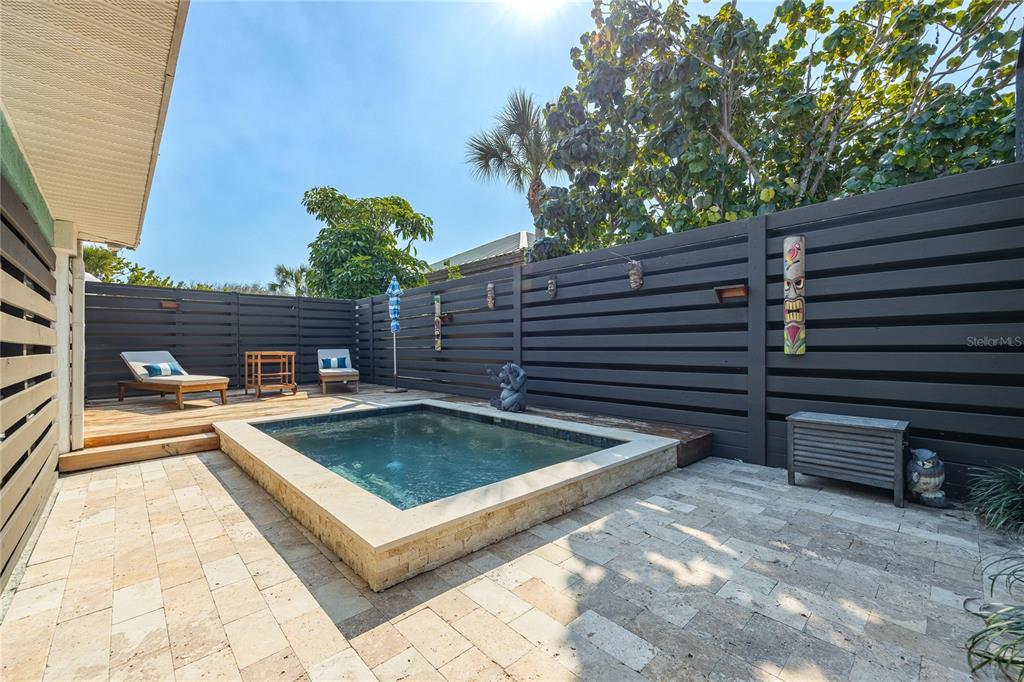 2630 North Beach Road Englewood, FL 34223 - Photo 14 of 98 a view of a backyard with chairs and a barbeque