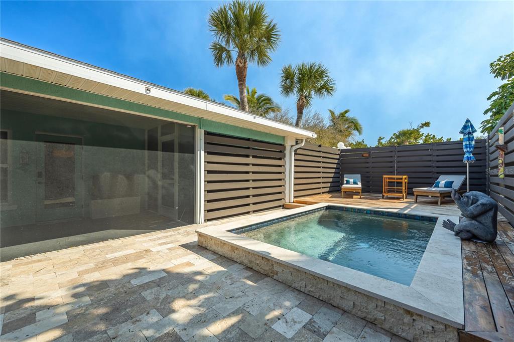 2630 North Beach Road Englewood, FL 34223 - Photo 16 of 98 a view of a swimming pool with a lounge chair