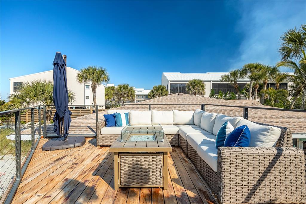 2630 North Beach Road Englewood, FL 34223 - Photo 20 of 98 a view of a roof deck with couches and sky view