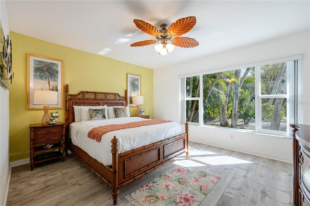 2630 North Beach Road Englewood, FL 34223 - Photo 23 of 98 a bedroom with a large bed and a large window