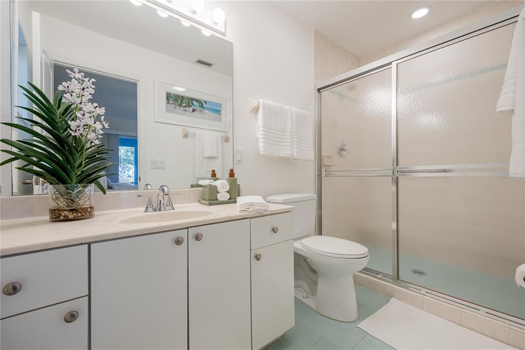 2630 North Beach Road Englewood, FL 34223 - Photo 29 of 98 a bathroom with a sink toilet and a mirror