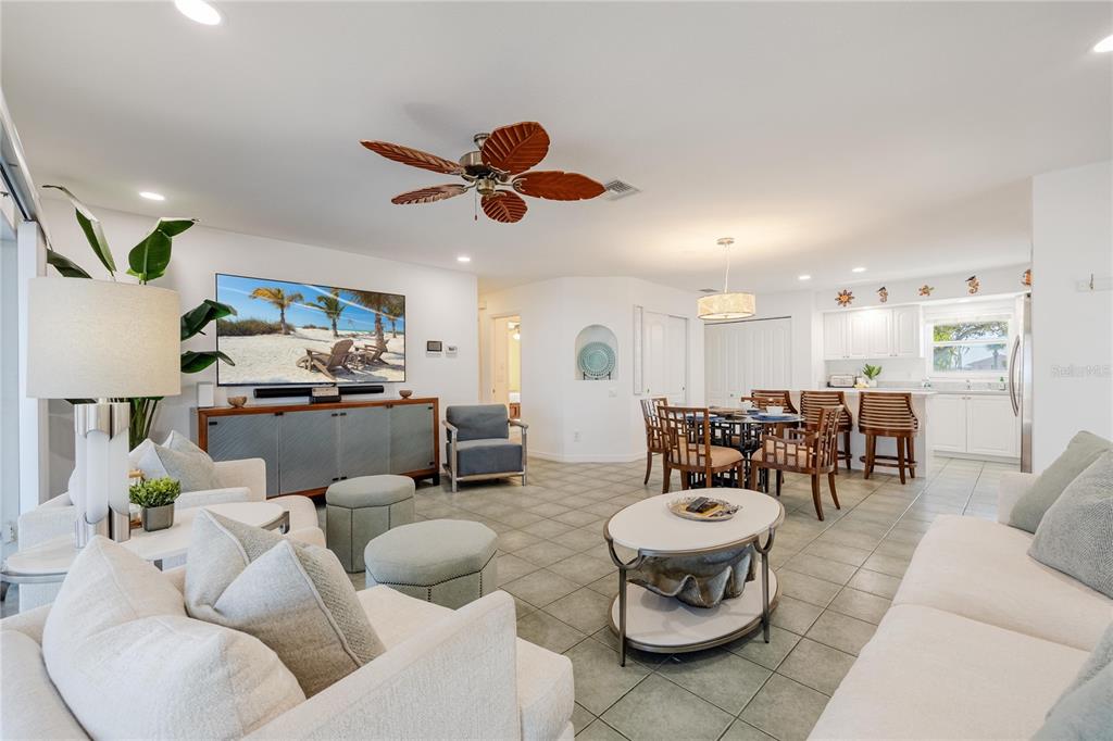 2630 North Beach Road Englewood, FL 34223 - Photo 36 of 98 a living room with furniture kitchen area and a chandelier