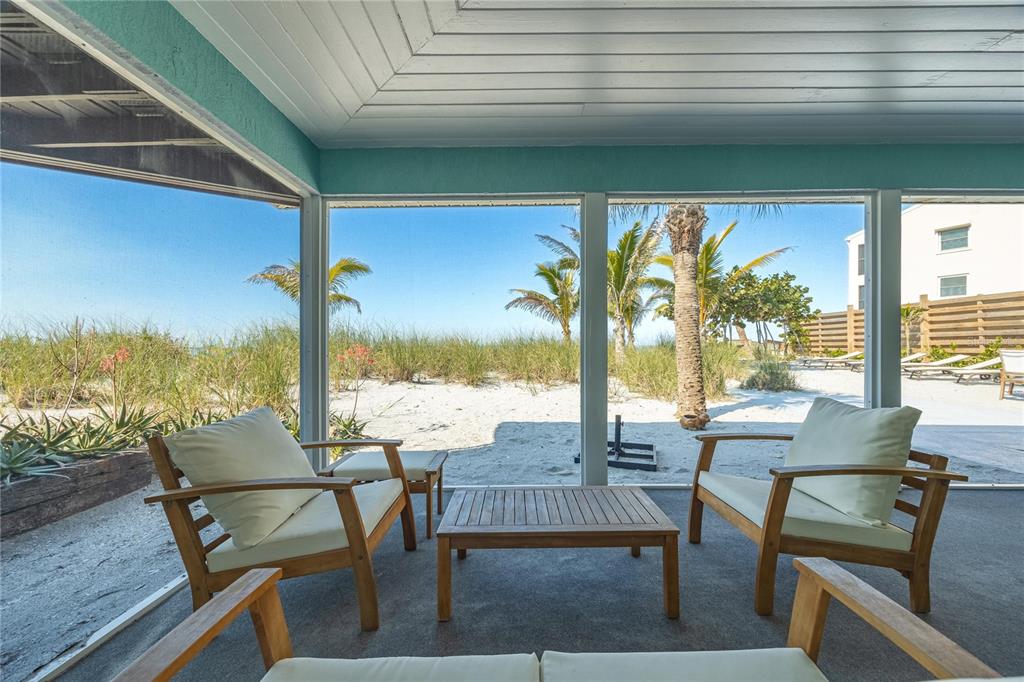 2630 North Beach Road Englewood, FL 34223 - Photo 50 of 98 a view of a patio with table and chairs and wooden floor
