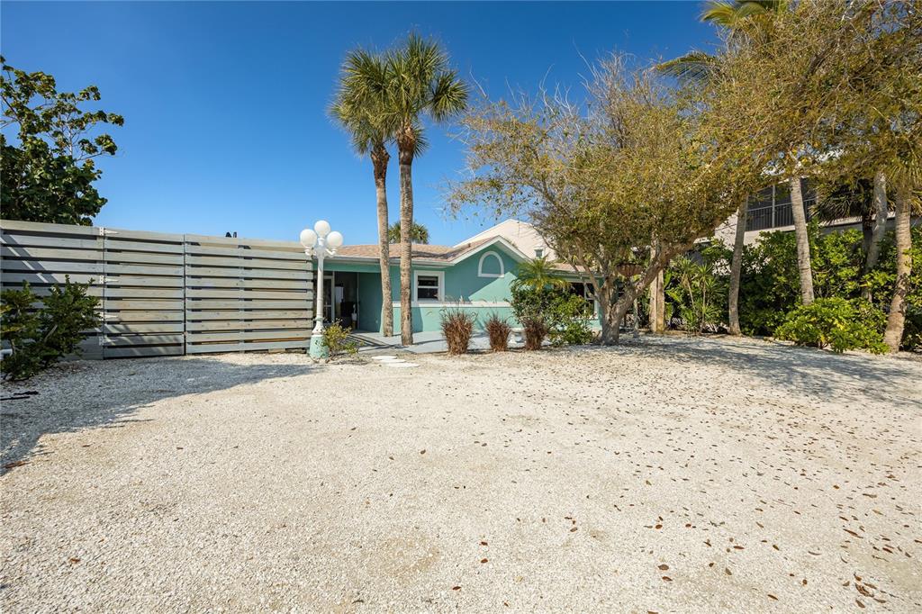 2630 North Beach Road Englewood, FL 34223 - Photo 64 of 98 a front view of a house with a yard and garage