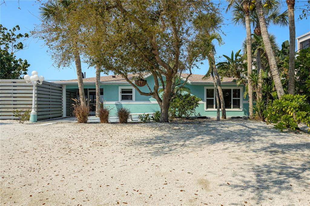 2630 North Beach Road Englewood, FL 34223 - Photo 65 of 98 a front view of a house with a yard and garage