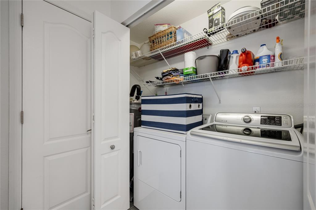 2630 North Beach Road Englewood, FL 34223 - Photo 67 of 98 a utility room with dryer washer and empty racks