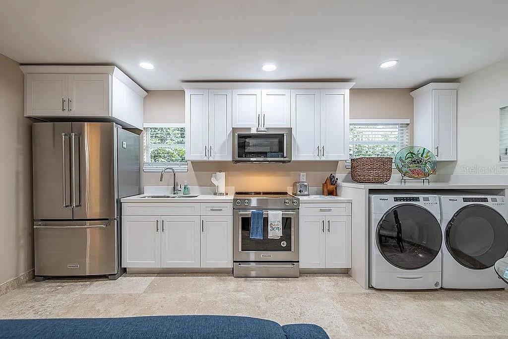 2630 North Beach Road Englewood, FL 34223 - Photo 94 of 98 a kitchen with a refrigerator and a stove top oven