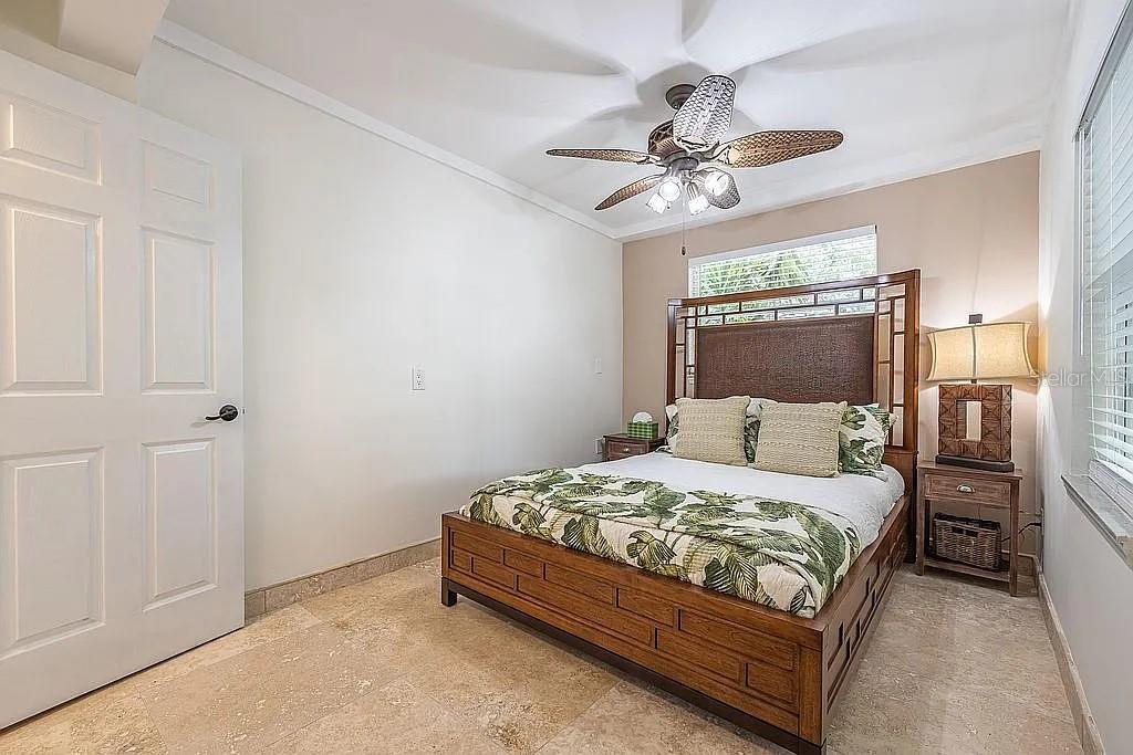 2630 North Beach Road Englewood, FL 34223 - Photo 95 of 98 a bedroom with a bed and a chandelier