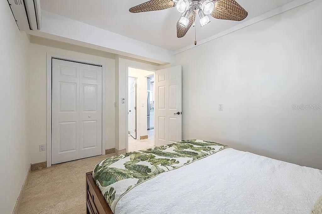 2630 North Beach Road Englewood, FL 34223 - Photo 96 of 98 a bedroom with a bed and a chandelier fan