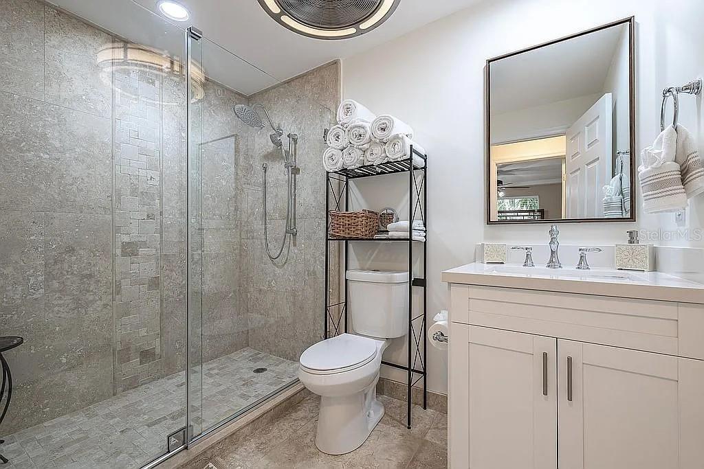 2630 North Beach Road Englewood, FL 34223 - Photo 97 of 98 a bathroom with a toilet a sink and mirror